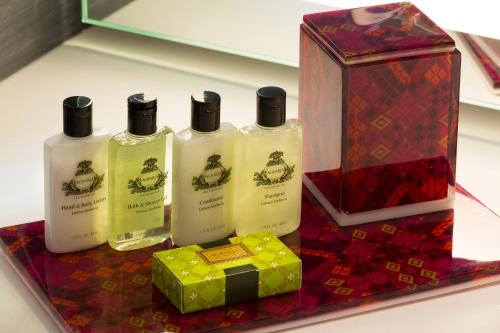 a group of four bottles of soap and a box at Presidente InterContinental Mexico City by IHG in Mexico City