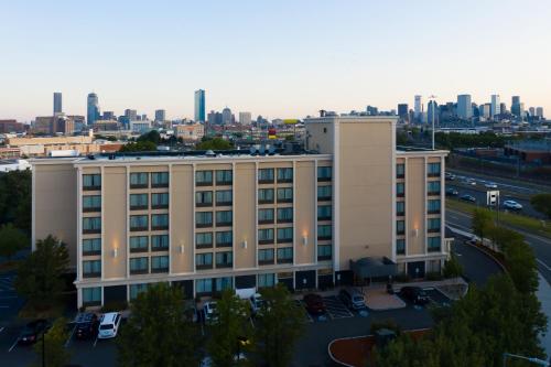 an apartment building with a city skyline in the background at Holiday Inn Express Boston by IHG in Boston