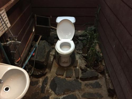 a bathroom with a toilet and a sink at Tree Lodge in Sen Monorom