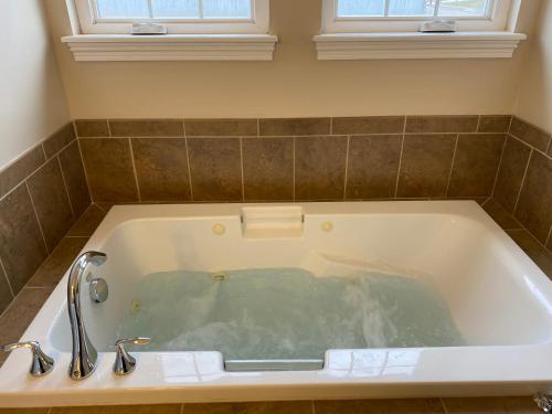a bath tub with two faucets in a bathroom at The La Grange House in Cleveland