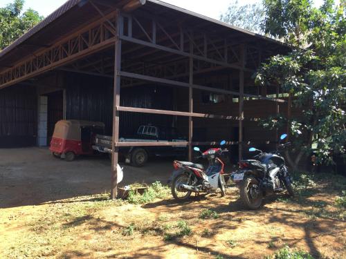 two motorcycles parked in front of a building at Tree Lodge in Sen Monorom