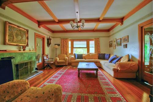 a living room with a couch and a fireplace at Melville House Bed and Breakfast in Lismore