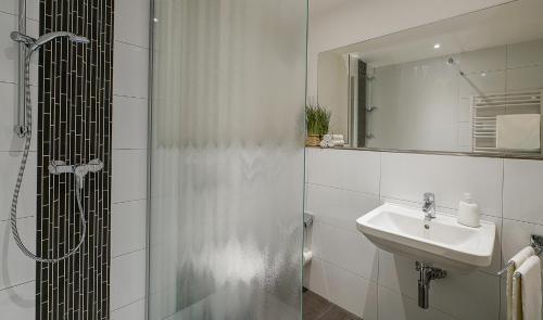 a bathroom with a shower and a sink at Hotel Chrisma in Düsseldorf