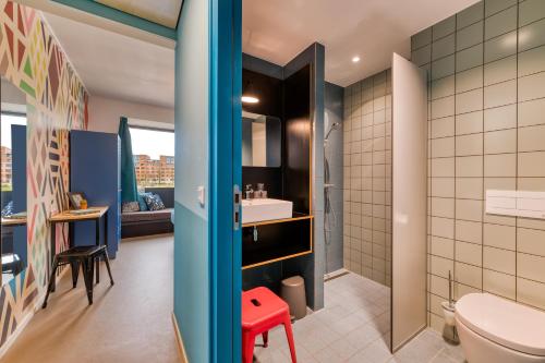 a bathroom with a toilet and a sink at Stayokay Hostel Maastricht in Maastricht