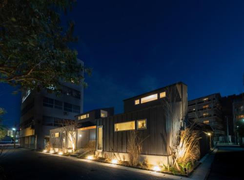 a house with lights on a street at night at Kamome Jyuku in Takamatsu