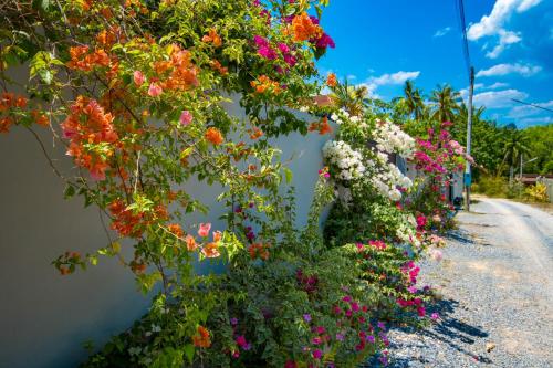 a row of flowers on the side of a building at Aonang nine poolvilla in Ao Nang Beach
