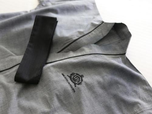 a black tie sitting on top of a gray shirt at APA Hotel Nihombashi Bakuroyokoyama Ekimae in Tokyo