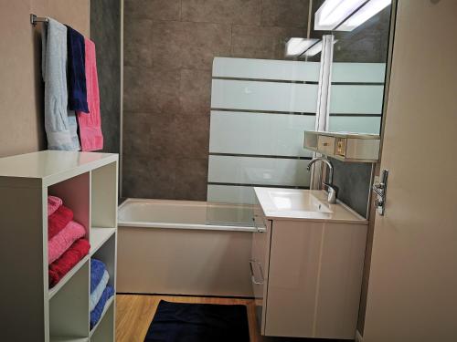 une salle de bain avec un lavabo et une baignoire dans l'établissement Studio vue mer L échappée normande, à Saint-Pierre-en-Port