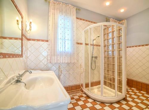 a bathroom with a shower and a sink and a tub at Villa Eden - Plusholidays in Calpe