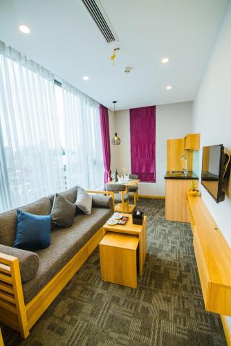 a living room with a couch and a table at HANA Stay in Hanoi