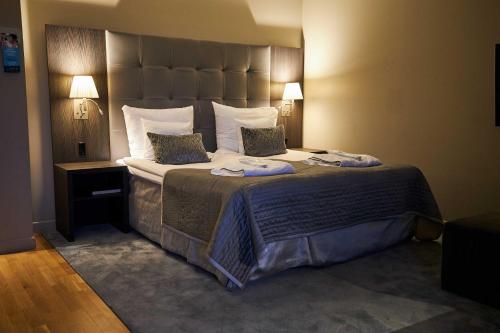 Postel nebo postele na pokoji v ubytování Clarion Hotel Post