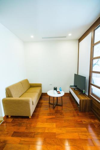 a living room with a couch and a table at HANA Stay in Hanoi