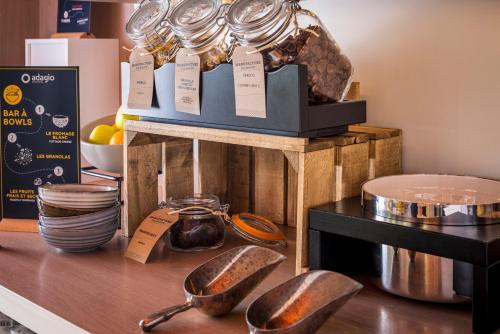 a counter with two spoons on top of a table at Aparthotel Adagio Access Paris Massy Gare in Massy