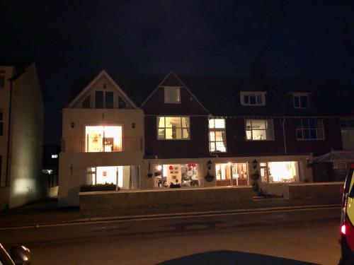 a large house at night with its lights on at Mariners Hotel in Seaton