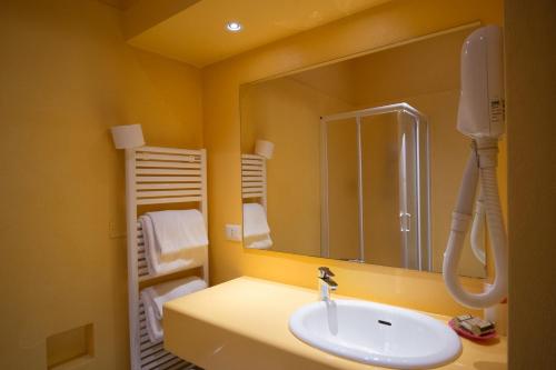 a bathroom with a sink and a mirror at Hotel Diana & Depandance in Lucca
