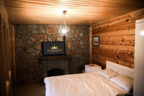 a bedroom with a bed and a tv on a fireplace at Havva Sultan Konağı in Trabzon