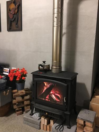 a fireplace with a stove in a room at LaVie GANDAN in Sanxing