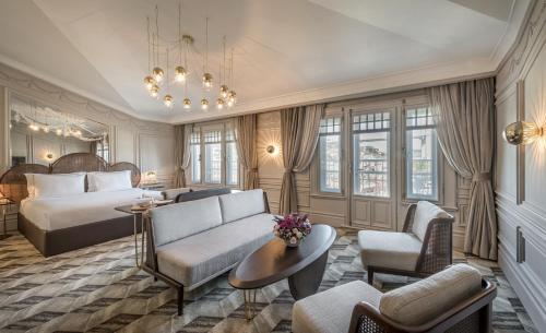 a hotel room with a bed and a couch and chairs at The Stay Bosphorus in Istanbul