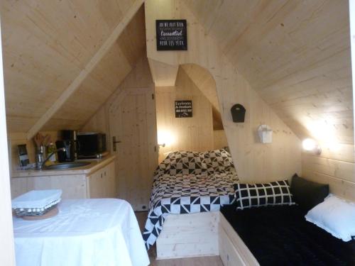 a room with two beds in a small room at Les cabanes de Kerellou in Plouigneau