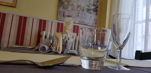 a table with two wine glasses on top of it at Hotel Eros in Lido di Camaiore
