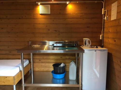 a small kitchen with a sink and a refrigerator at Camping Engelbert (Groningen) in Groningen