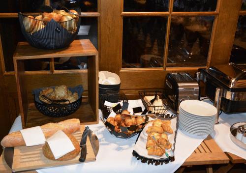a table with bread and other food on it at Genusshotel Hirschen - Erholung im Grünen (Südschwarzwald) in Sallneck