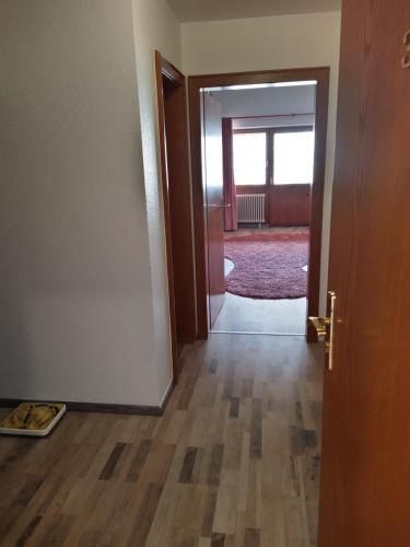 an open door to a room with a wooden floor at Hotel Faller in Breitnau