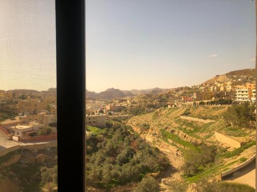 a view of a city from a window at Petra Plaza Hotel in Wadi Musa