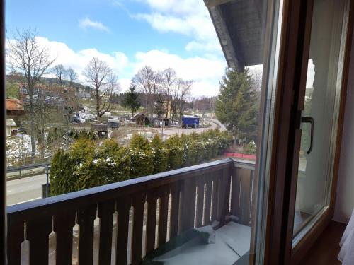 a window of a balcony with a view of a street at Hotel Faller in Breitnau