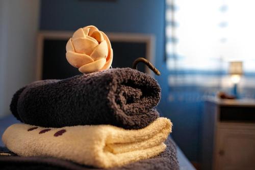 a stuffed animal is sitting on a bed at Alojamiento Rural Pueblo de la Ribera in Peñafiel
