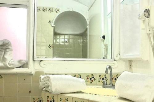 a bathroom with a sink and a mirror at Spectacular Hadas Sunset and Ocean view in Manzanillo