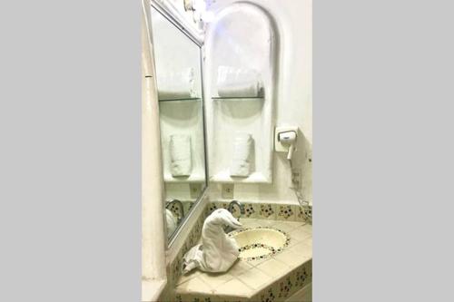 a bathroom with a sink and a mirror at Spectacular Hadas Sunset and Ocean view in Manzanillo