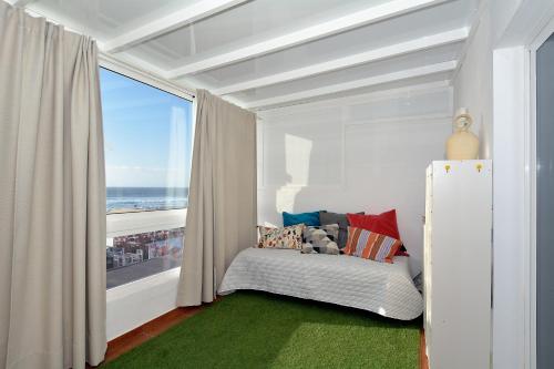 a room with a bed with a window with a view of the ocean at Top Sea Views in El Golfo Prime location By PVL in El Golfo