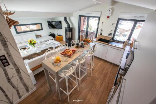 a kitchen and dining room with a table and chairs at Chalet Hygge Saint Lary - ressourcez-vous dans les Pyrénées in Saint-Lary-Soulan