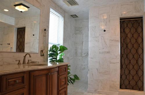 a large bathroom with a sink and a mirror at The Flanders Hotel in Ocean City