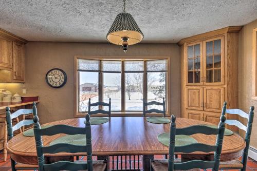 a dining room with a table and chairs and a window at Simple Cranberry and Wine Farm Home with Fire Pit! in Eagle River