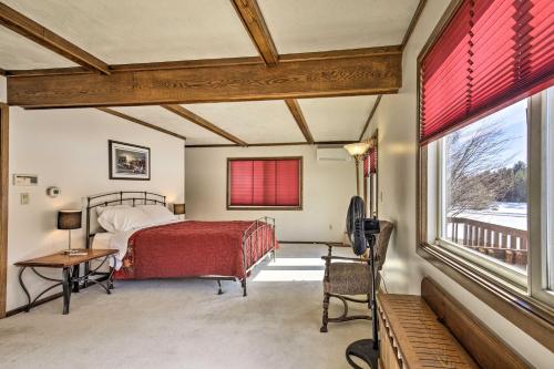 a bedroom with a bed and a desk and a window at Simple Cranberry and Wine Farm Home with Fire Pit! in Eagle River