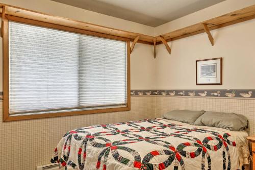 a bedroom with a bed and a window at Simple Cranberry and Wine Farm Home with Fire Pit! in Eagle River