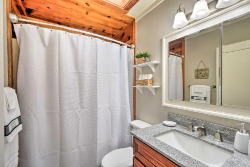 a bathroom with a white shower curtain and a sink at Private Pool, Hot Tub and Yard Serene Murphy Home in Murphy