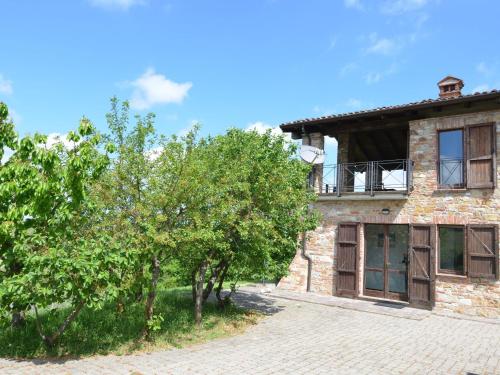 an external view of a stone house with trees at Belvilla by OYO Casa Magnano Ziano in Ziano Piacentino