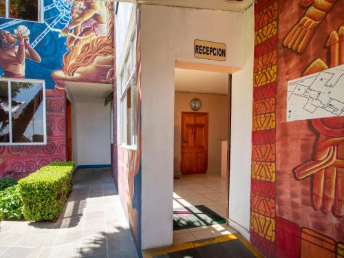 a hallway of a building with a mural on the wall at Hotel De La Loma in Tlaxcala de Xicohténcatl