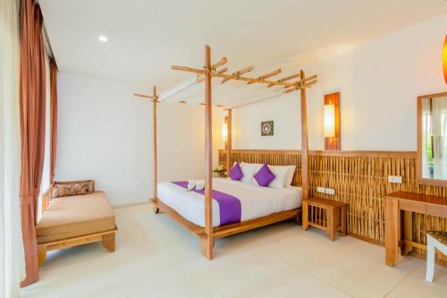 a bedroom with a canopy bed and a desk at Railay Bay Resort & Spa in Railay Beach