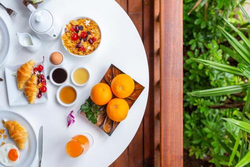 a white table with eggs and fruit on it at Railay Bay Resort & Spa in Railay Beach