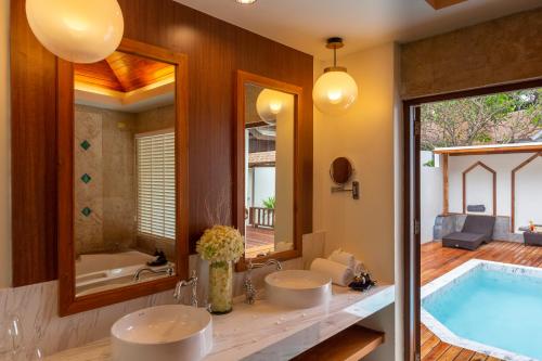 a bathroom with two sinks and a tub at Railay Bay Resort & Spa in Railay Beach