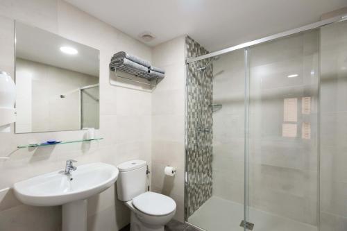 a bathroom with a toilet and a sink and a shower at Apartamentos Turísticos San Lorenzo in Nájera