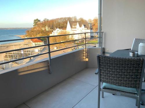 a balcony with a table and a view of the water at Appartement _An der Seebruecke_ in Glücksburg