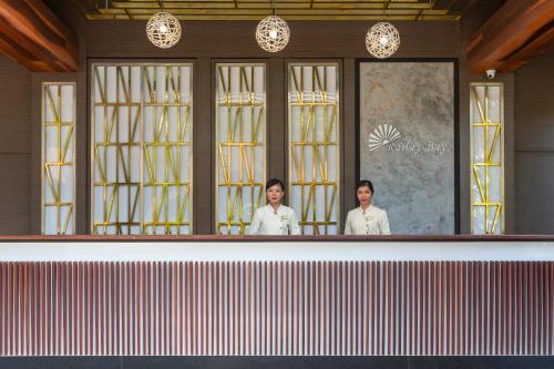two women standing behind a counter in a restaurant at Railay Bay Resort & Spa in Railay Beach