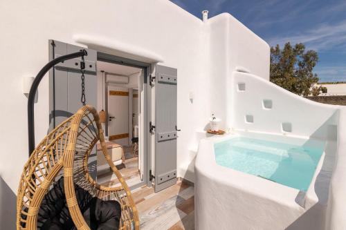une villa avec un bassin profond et une balançoire dans l'établissement NAXIAN SUNSET VILLAS, à Naxos Chora