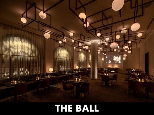 a dining room with tables and chairs and lights at UNWIND HOTEL & BAR OTARU in Otaru
