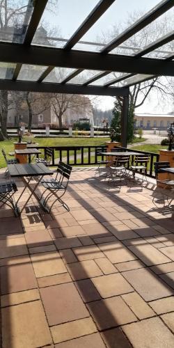 a group of picnic tables and chairs in a park at Hotel Altes Badehaus in Bad Dürrenberg